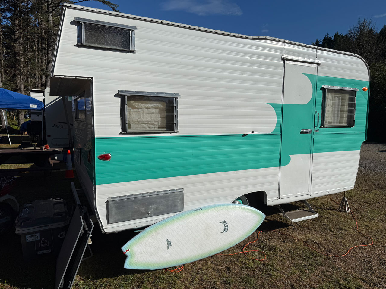 Lib Tech Pisces surfboard next to a camping trailer.